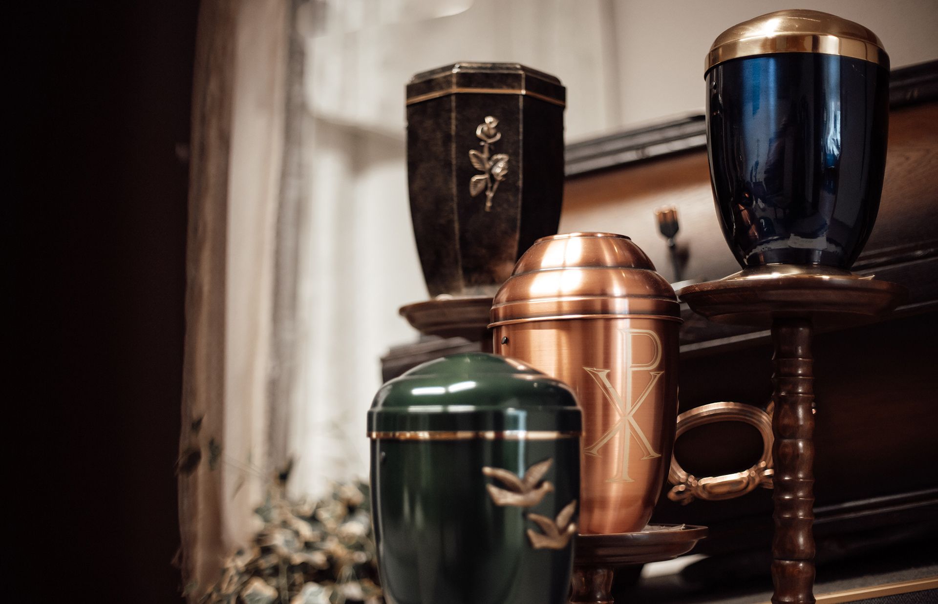 A group of urns sitting on top of a wooden table.