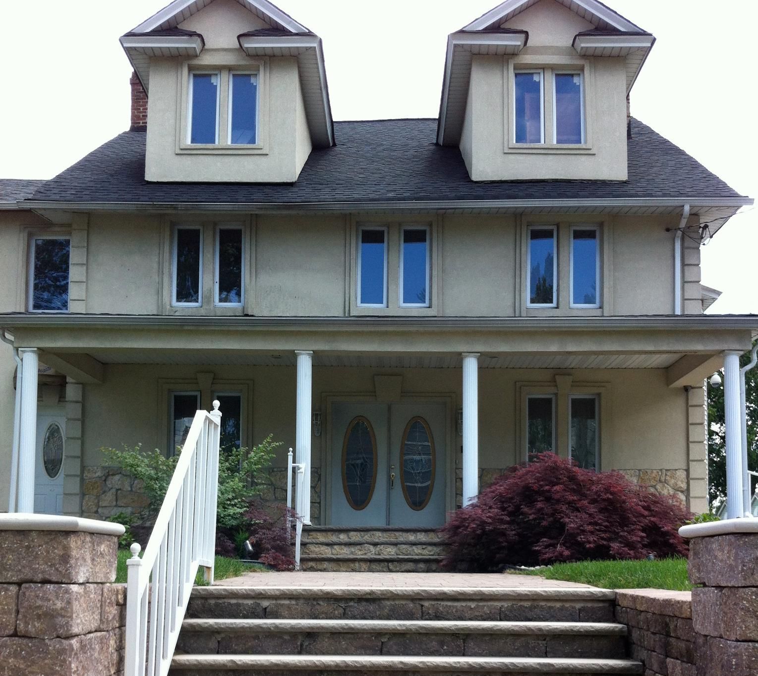 A large white house with stairs leading up to it