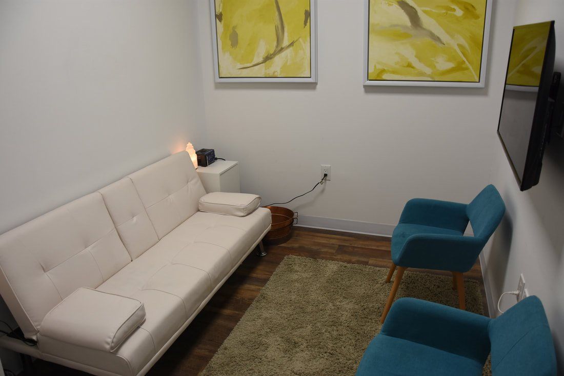 There is a couch and two chairs in the room.