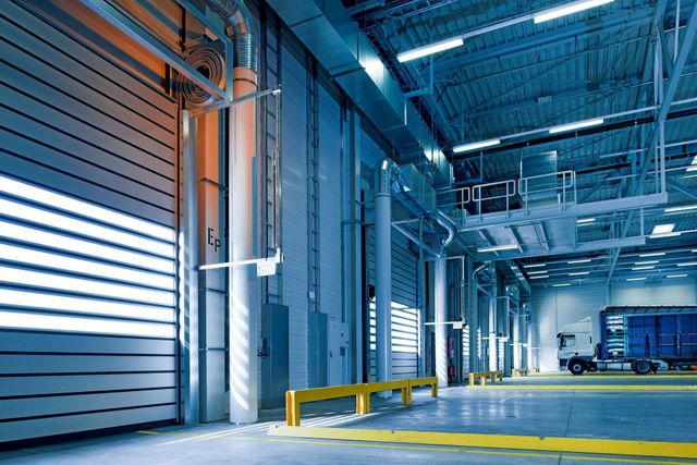 A large warehouse with a truck parked in the back