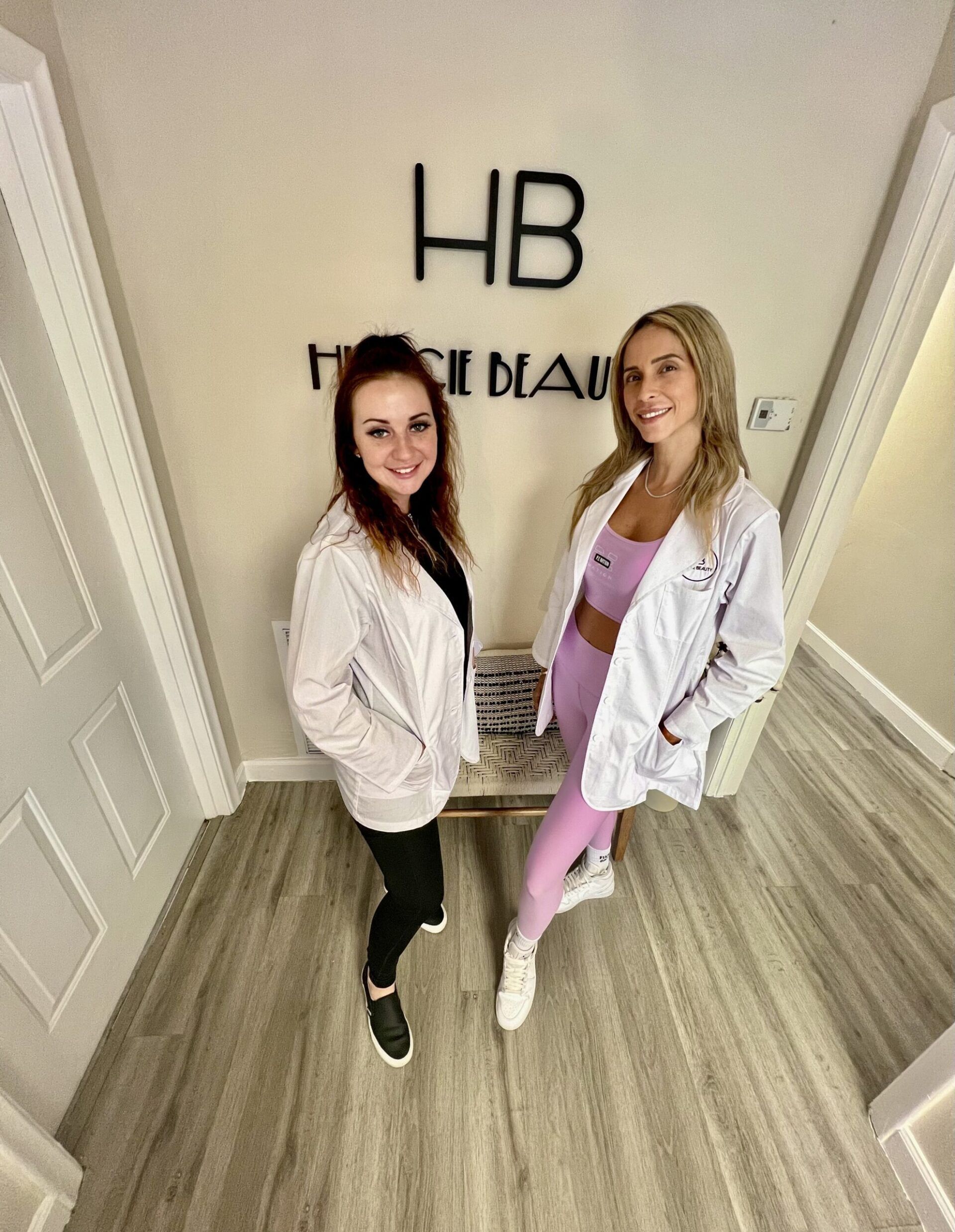 two women standing near facing each other while looking towards camera