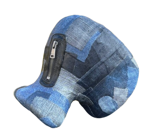 Een abstracte, opgezette vissculptuur gemaakt van patchwork blauwe denimstof met een zwarte leren ritssluiting aan de zijkant.