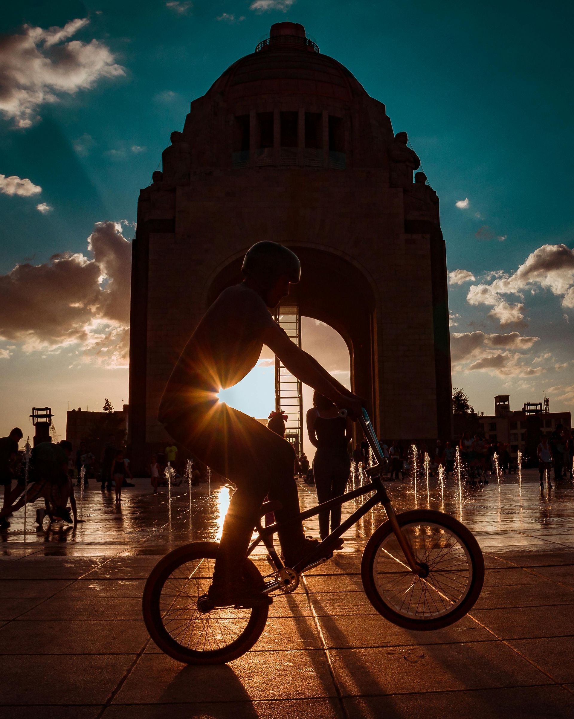 Two men are riding bicycles down a city street.