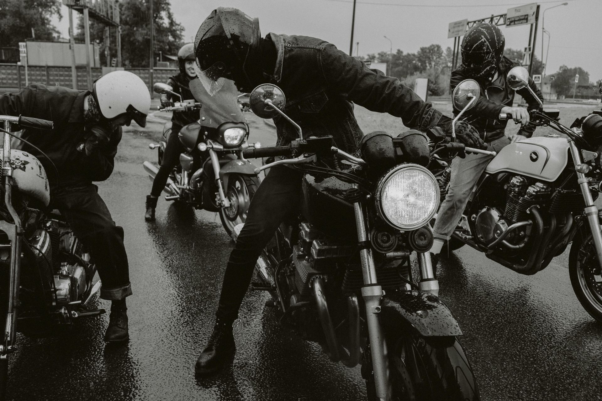 A man is riding a motorcycle down a city street.