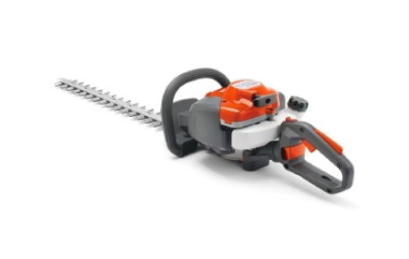 Un tagliasiepi è appoggiato su una superficie bianca.