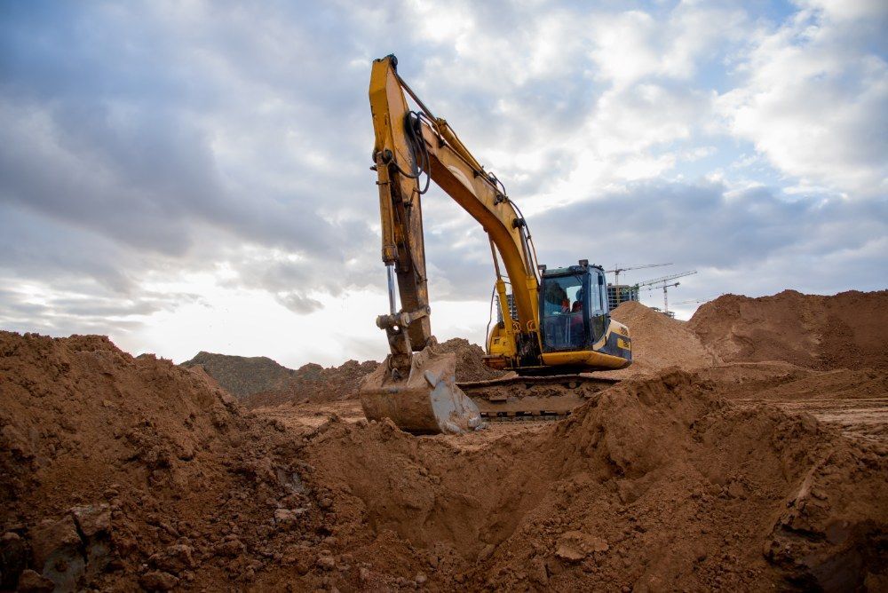 A Yellow Excavator is Digging the Dirt — Jammach Earthmoving in Newcastle, NSW