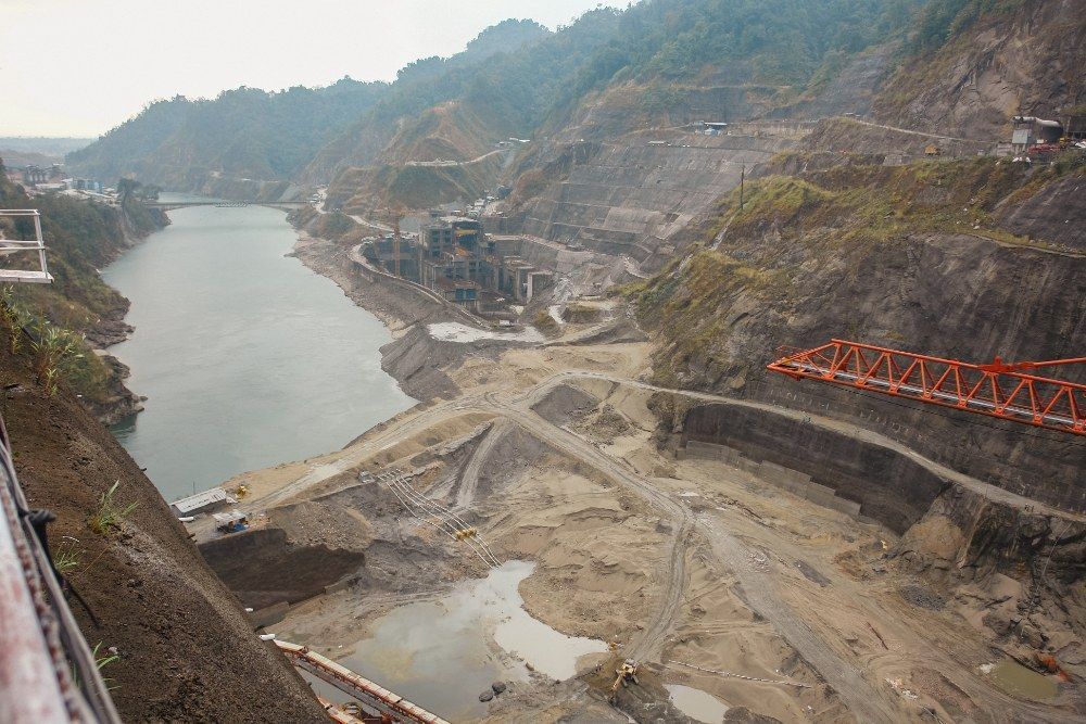 An Aerial View of a Dam Construction Surrounded by Mountains — Jammach Earthmoving in Mid North Coast, NSW