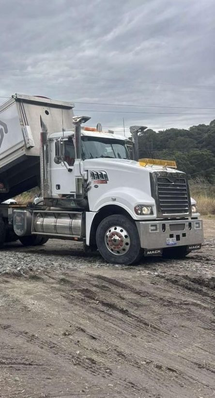A Dump Truck Is Parked in A Dirt Field — Jammach Earthmoving in Nulkaba, NSW