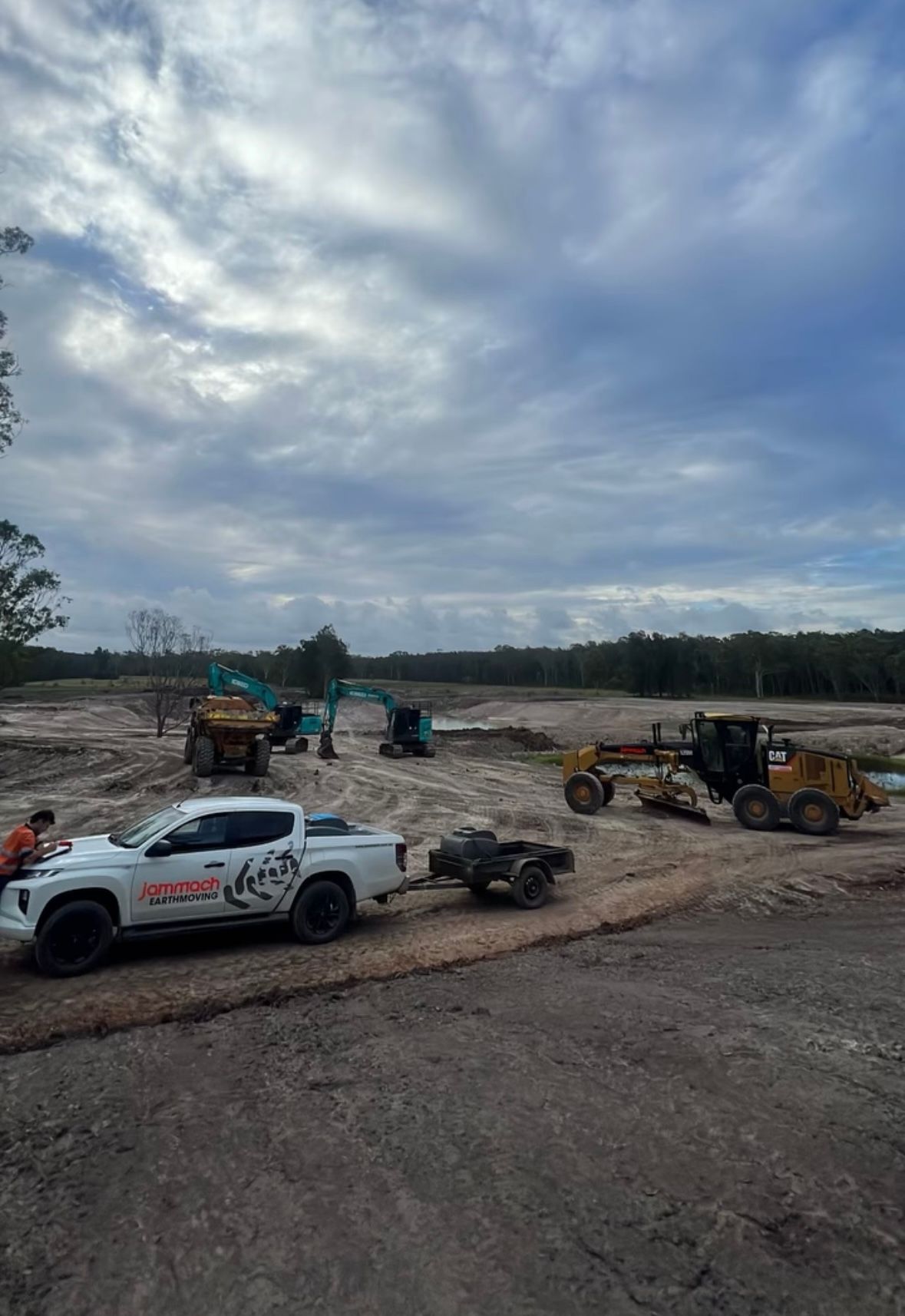 A White Truck is Parked on the Side of the Road Next to a Construction Site — Jammach Earthmoving in Nulkaba, NSW