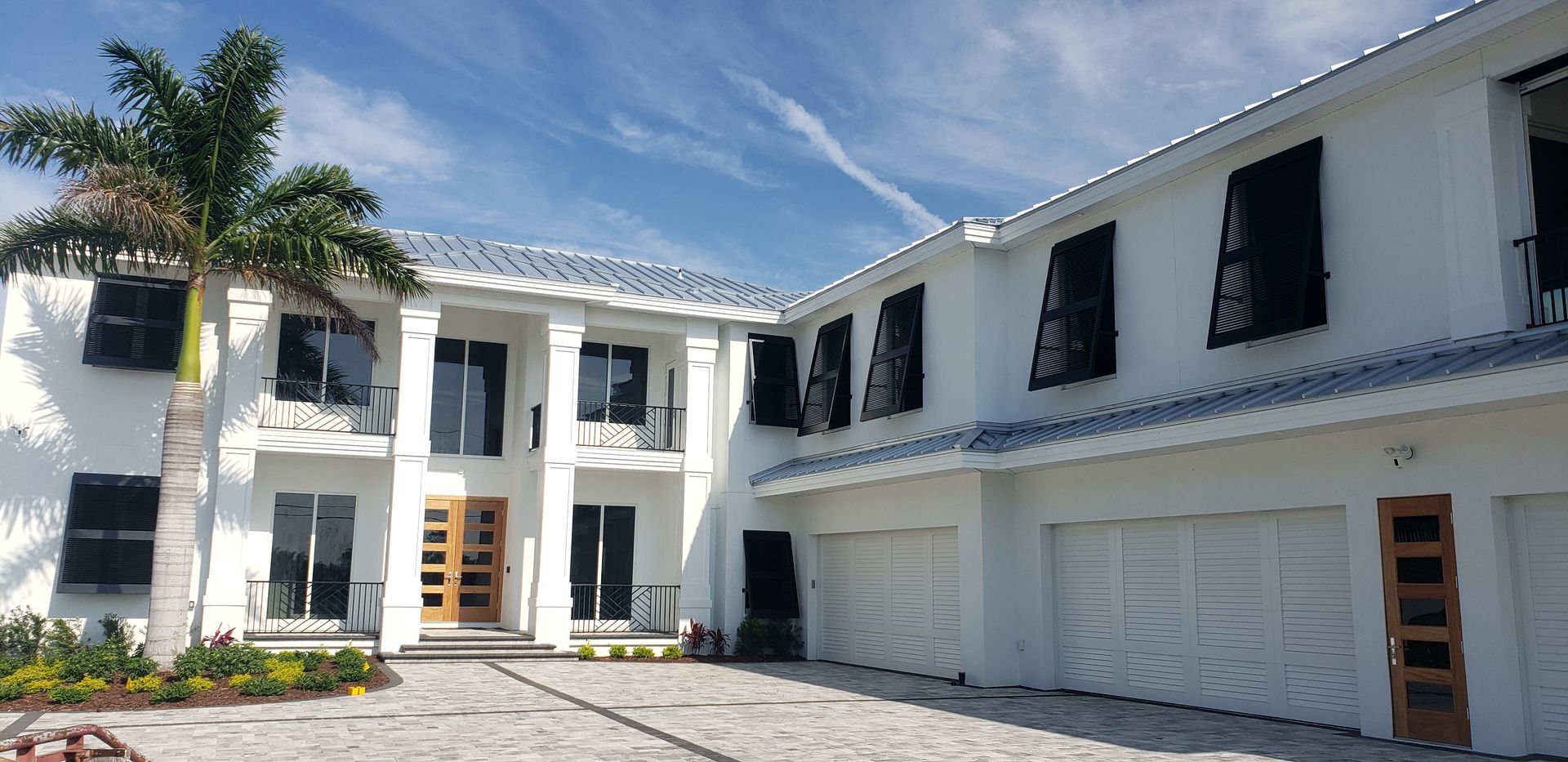A white house with black shutters on the windows