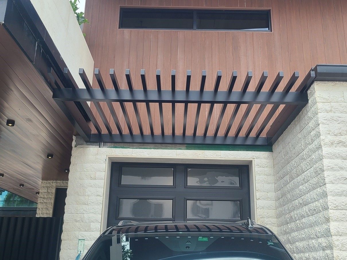 A balcony with wicker furniture and a view of a field
