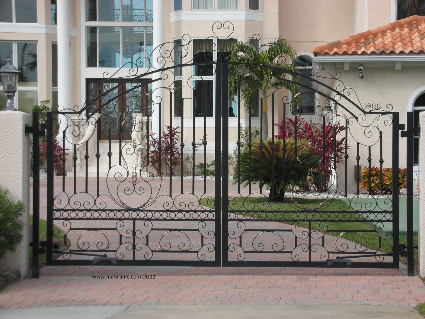 A wrought iron gate in front of a house