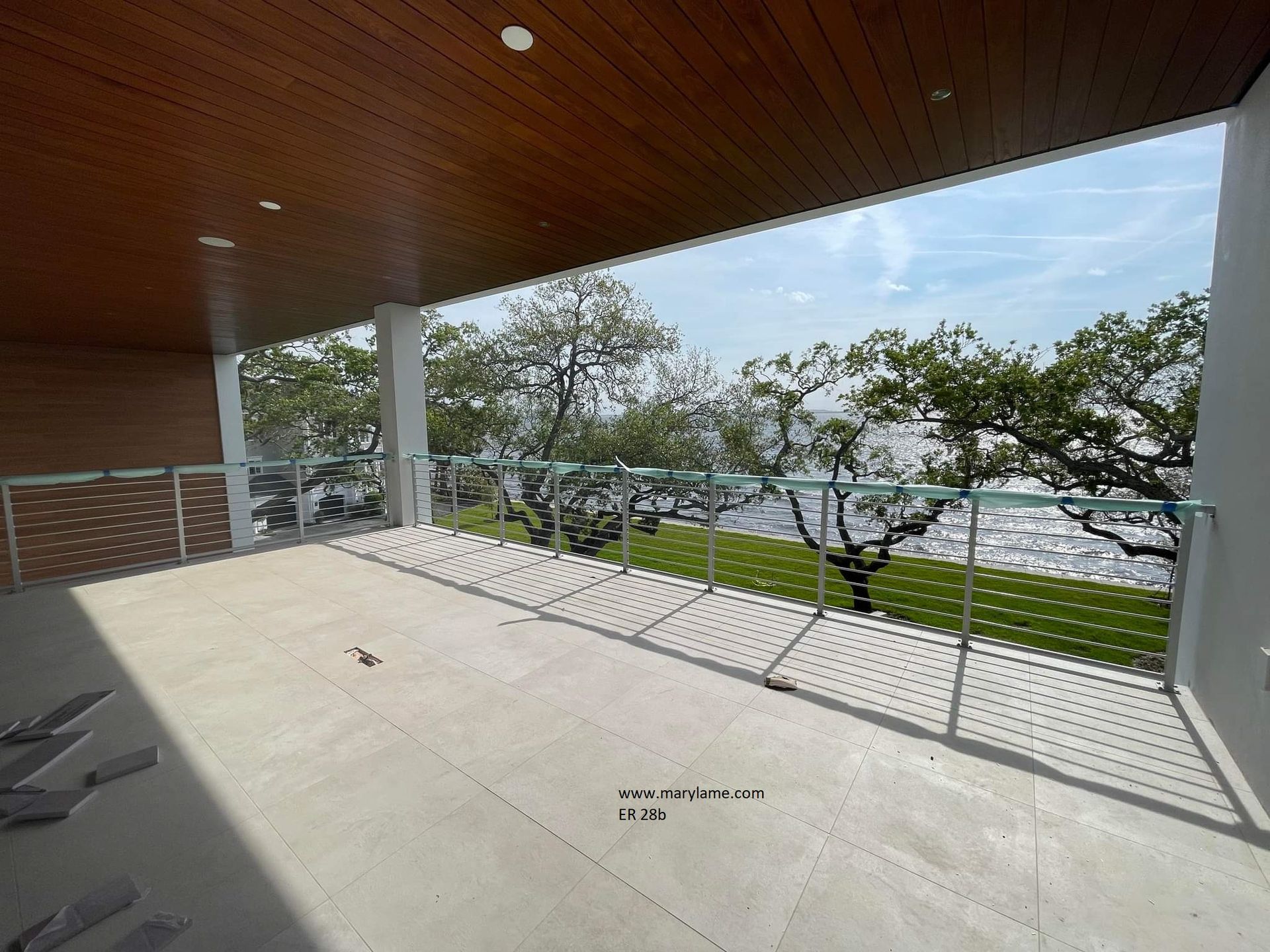 A balcony with a view of a lake and trees