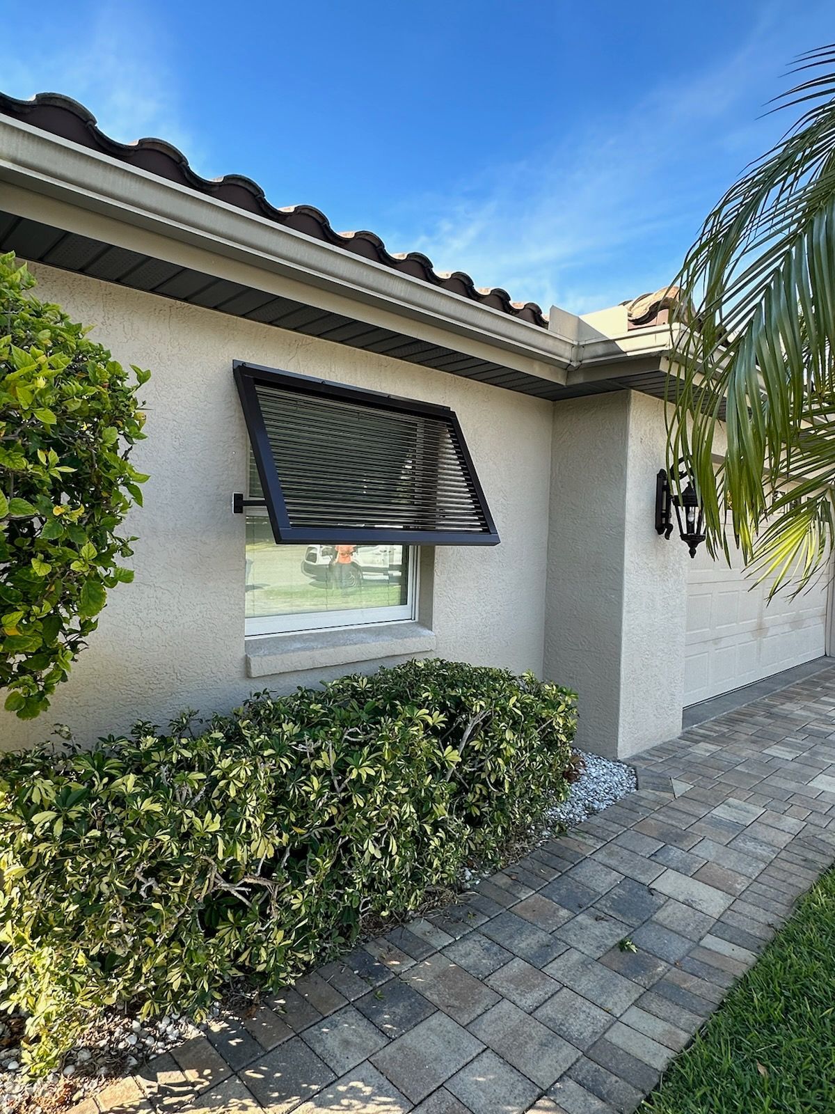 A close up of a white metal shutter on a building.
