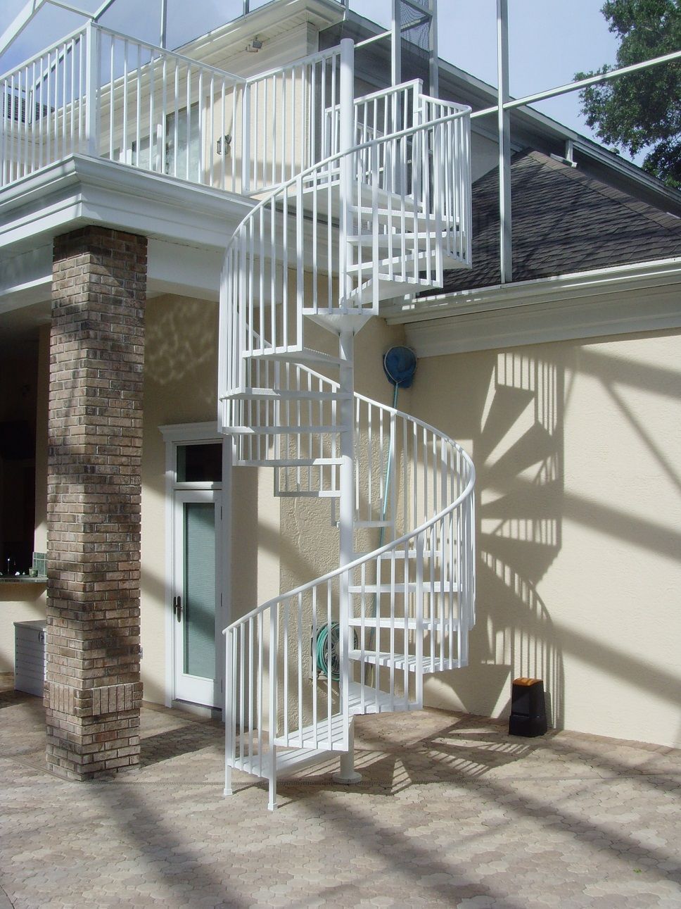 A spiral staircase on the side of a house