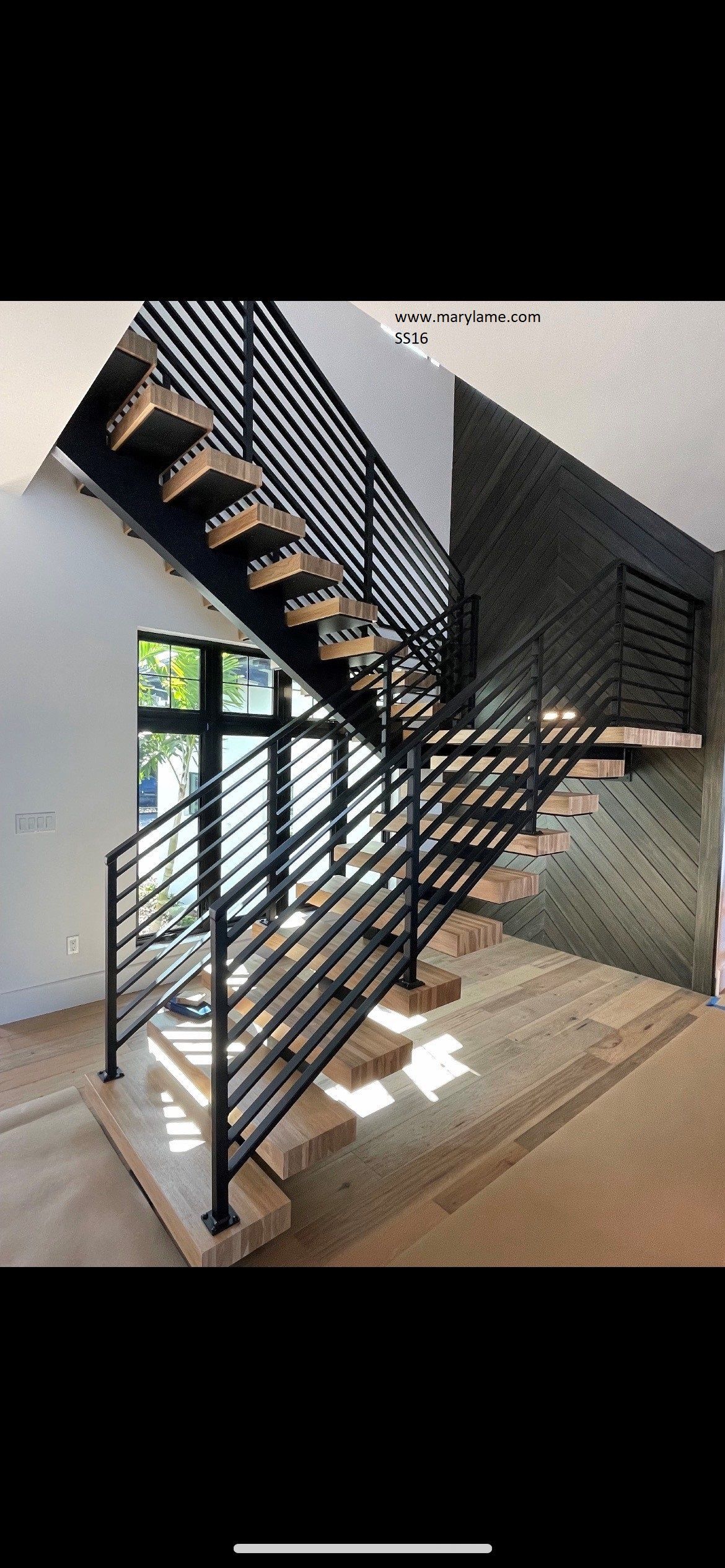 A picture of a staircase in a house under construction.