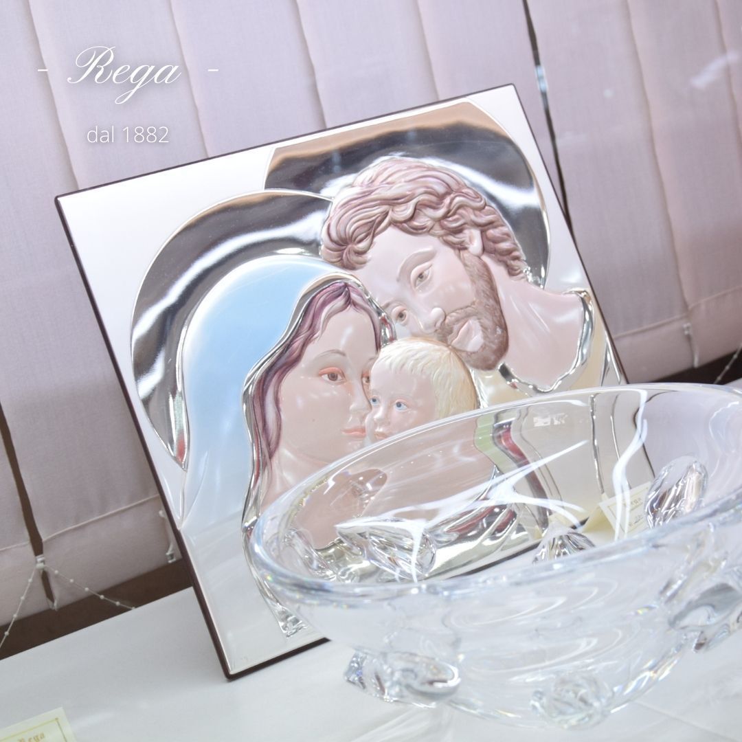 Un'immagine della Sacra Famiglia è su un tavolo accanto a una ciotola di vetro.