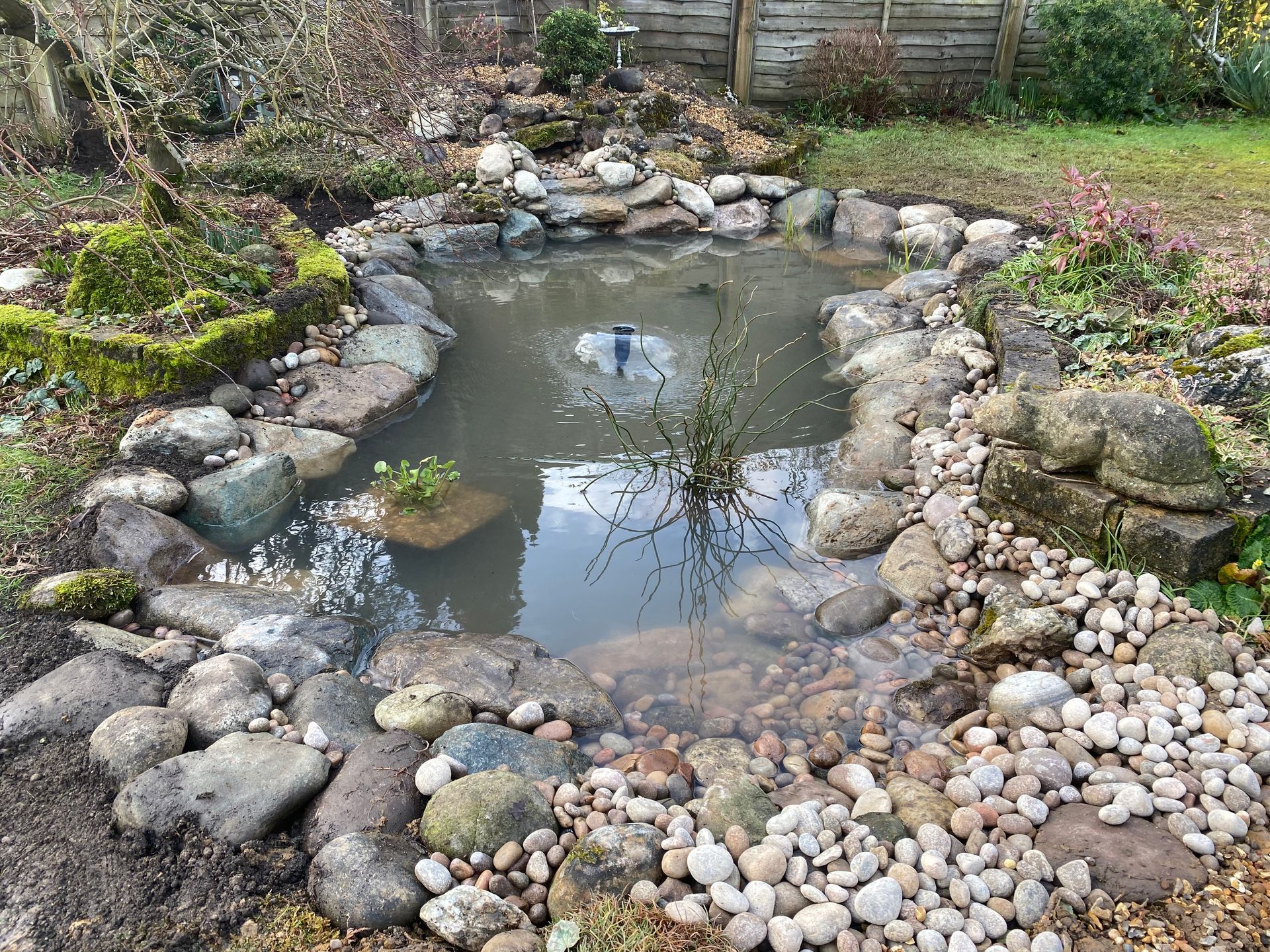 Natural stone edged garden pond in rural Hertfordshire