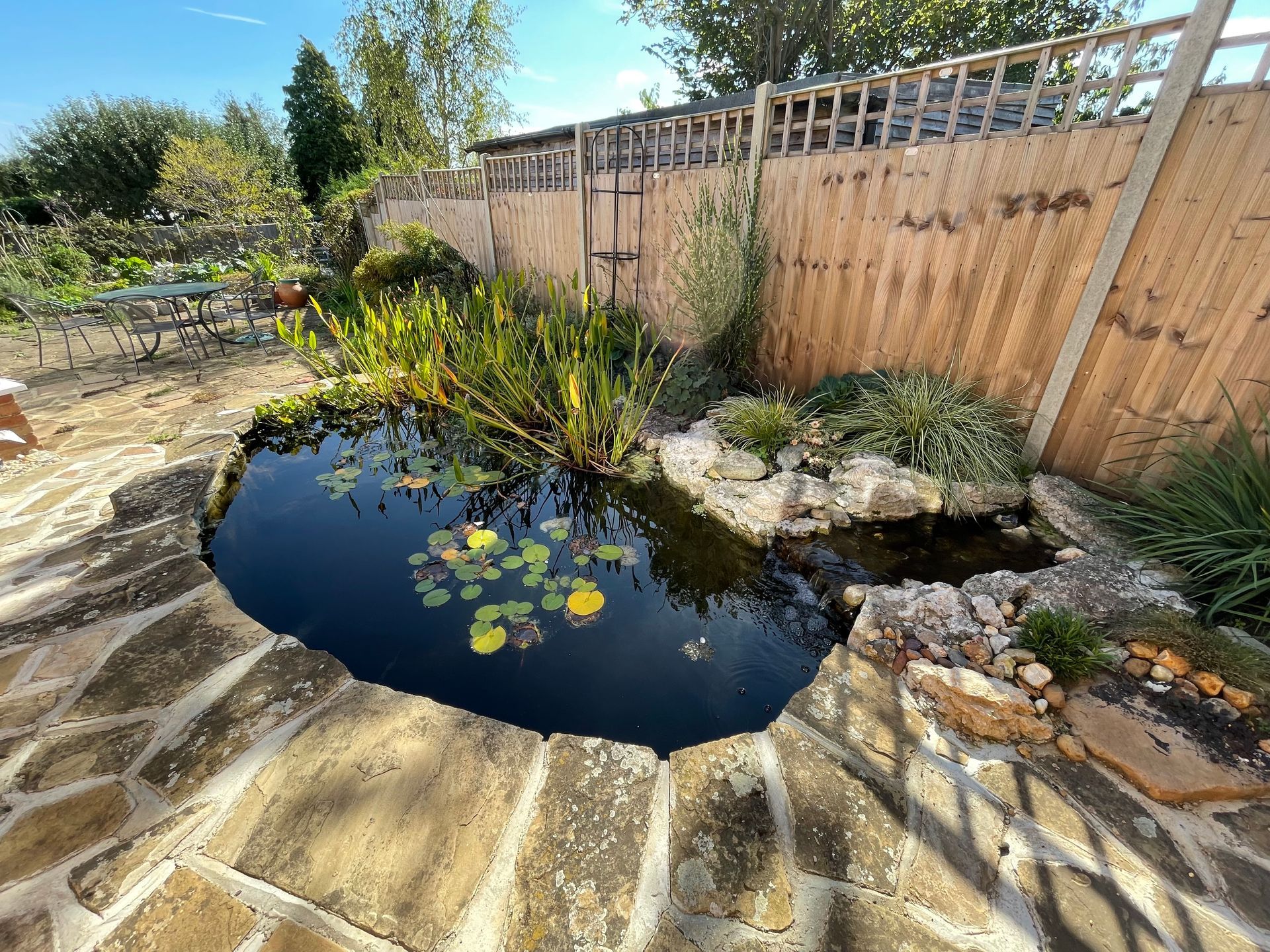 Natural stone edged garden pond in rural Hertfordshire