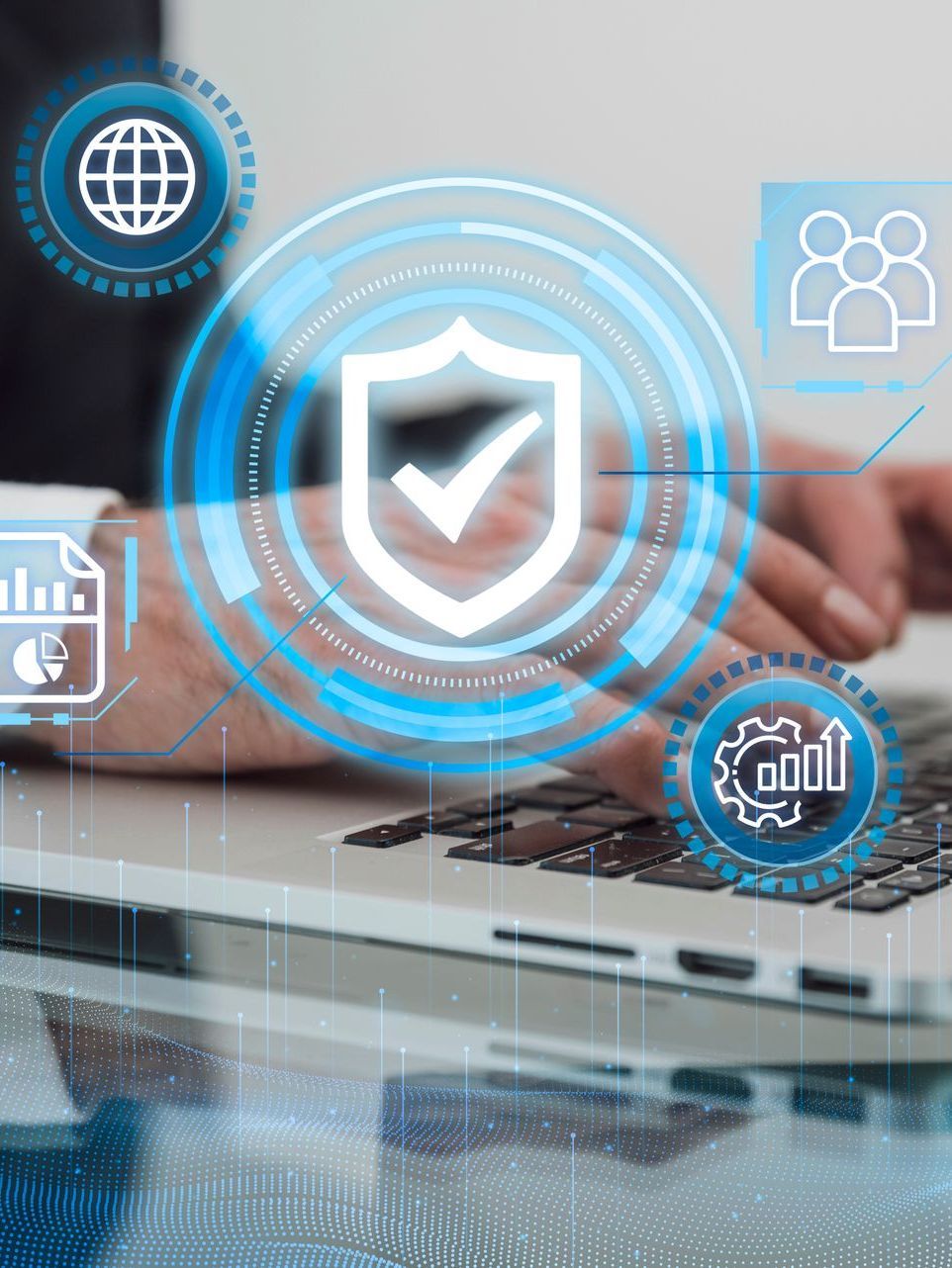 Person using a laptop with a cybersecurity graphic overlay; blue and white icons.