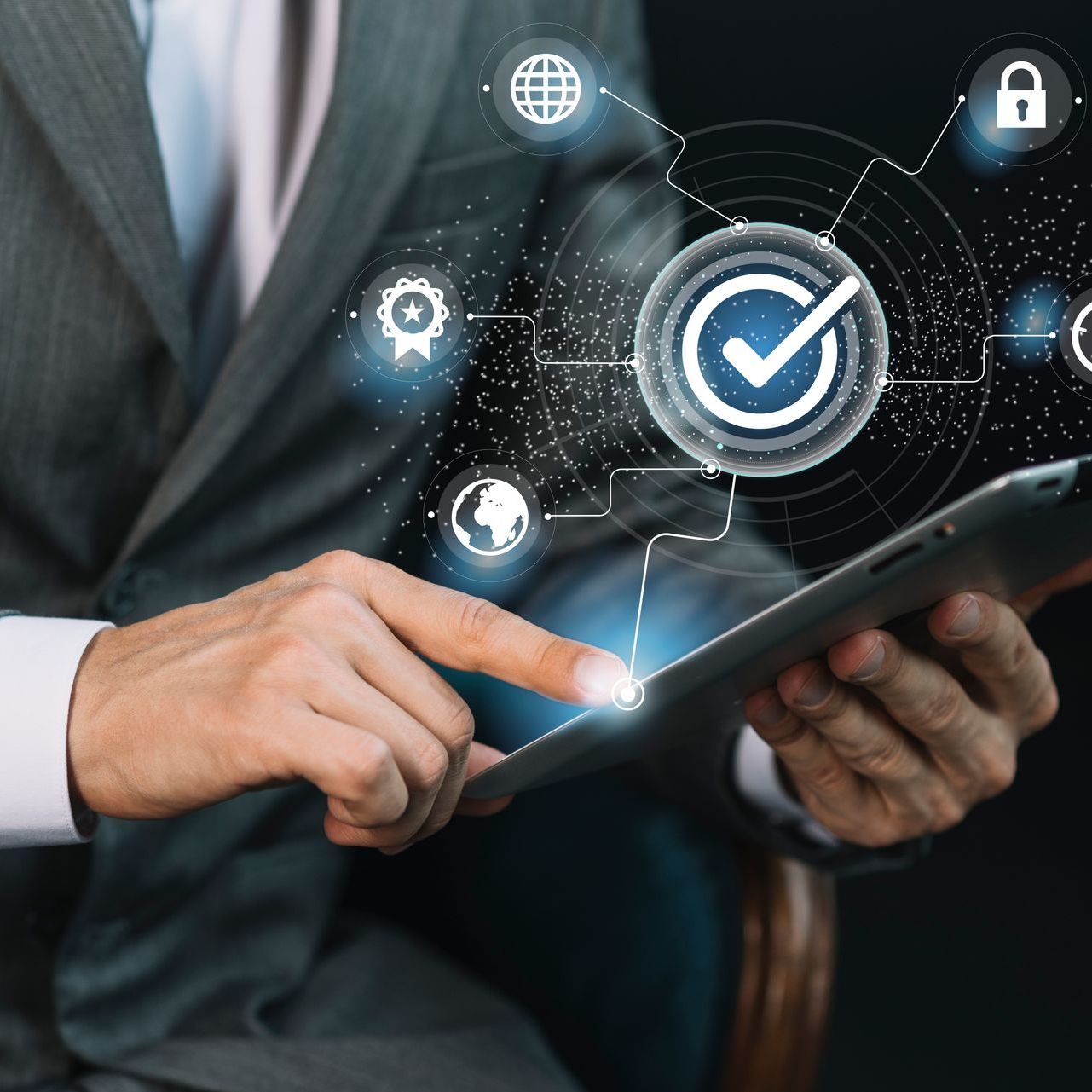 Businessman using tablet with digital quality assurance icons.