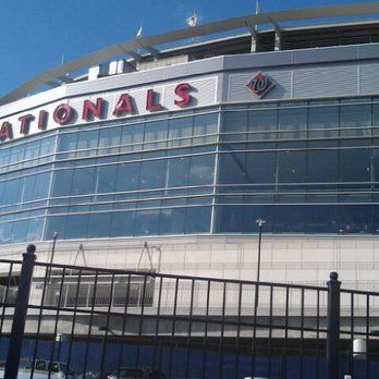 Exterior of Nationals Park baseball stadium in Washington, D.C., featuring the team's red signage and logo.