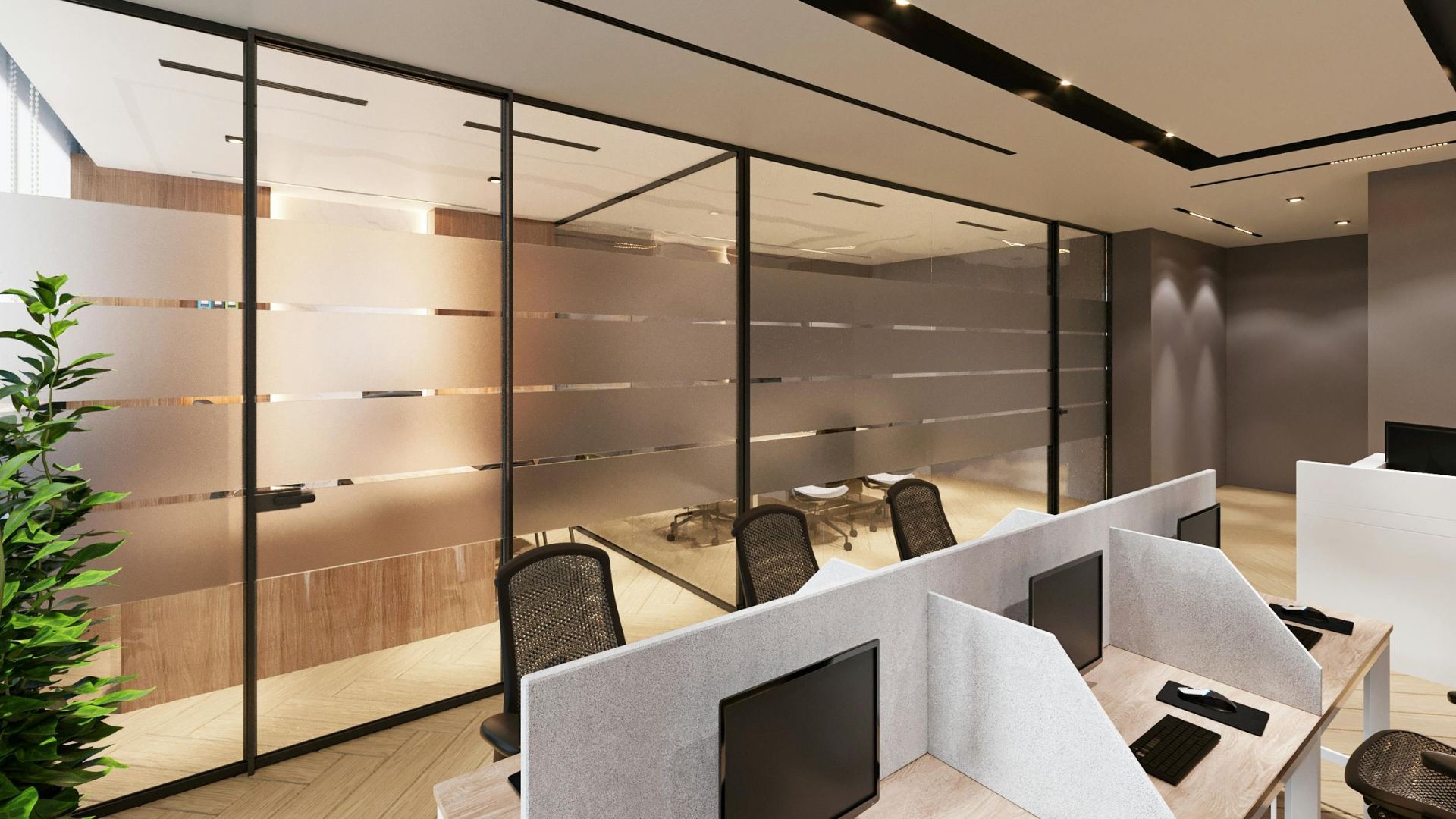 Modern office interior featuring a glass-partitioned conference room and desk cubicles with computers.