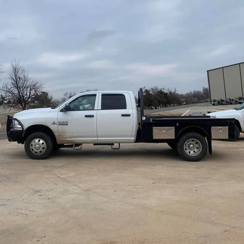 white dodge truck with black skirted flatbed