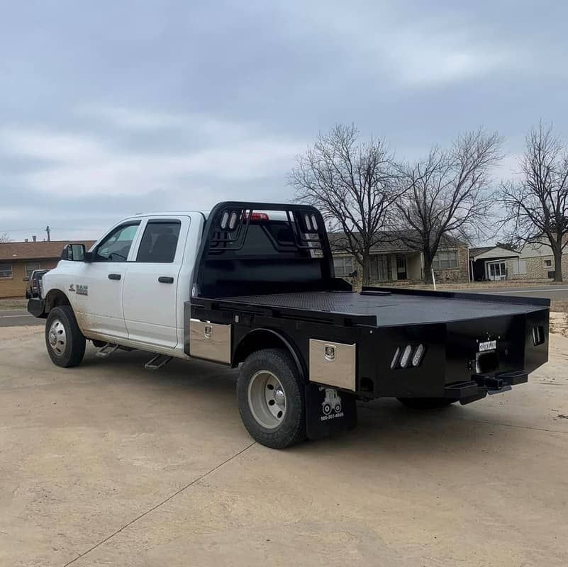 white dodge truck with black skirted flatbed