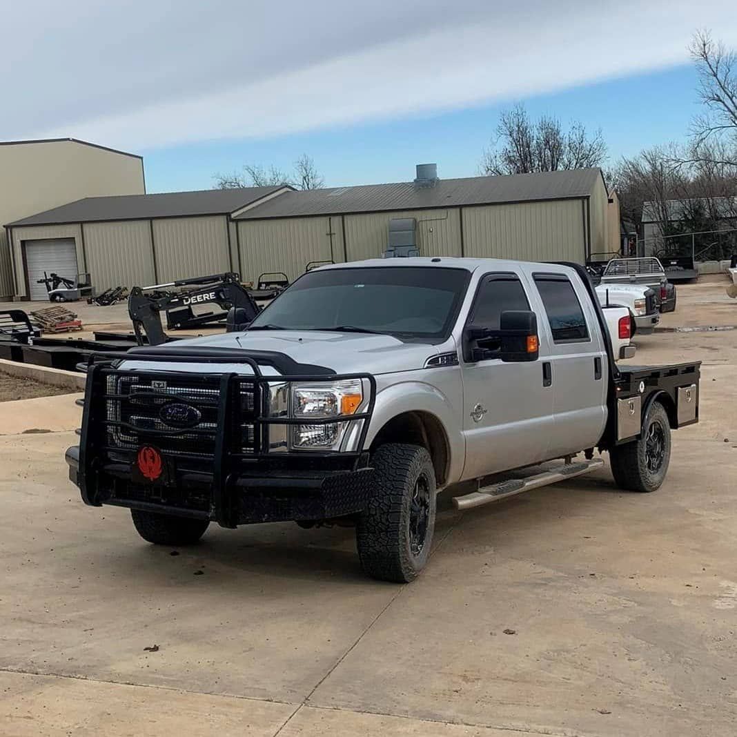 silver ford crew cab with black skirted flatbed