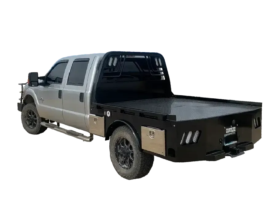 Silver 4 door truck with black flatbed with side skirts and tool boxes