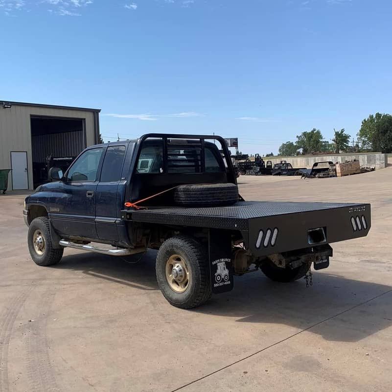 blue dodge truck with black flatbed