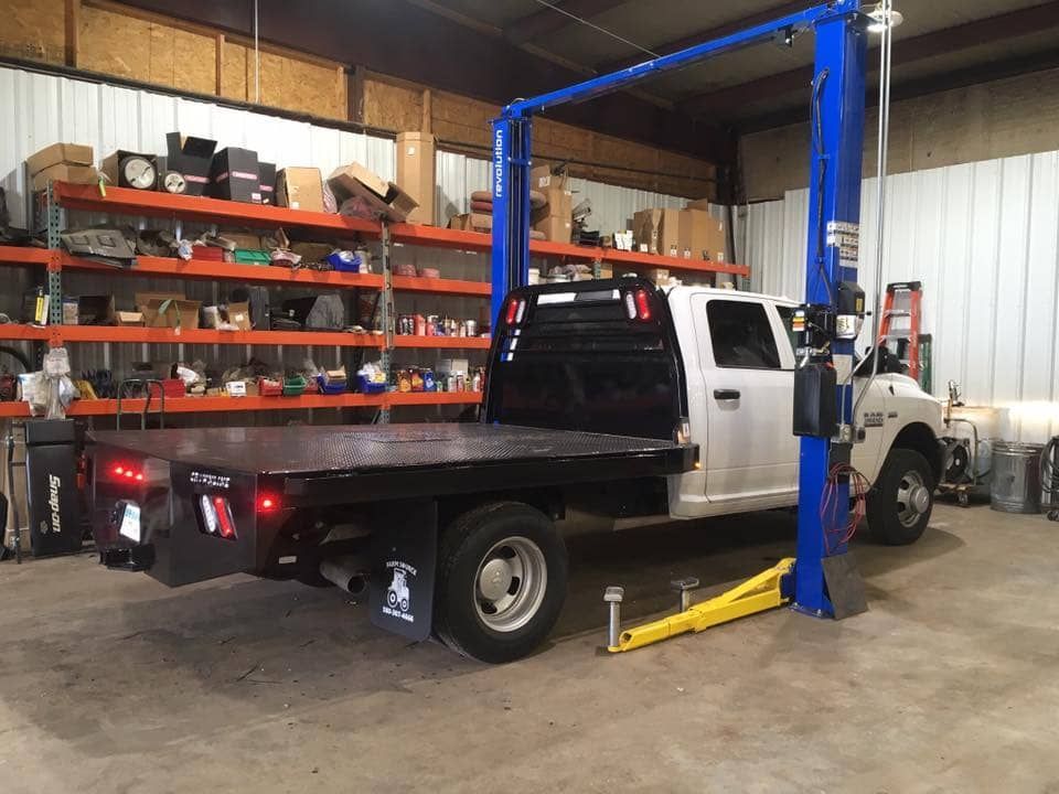 photo of truck in service area pulled between lift rails