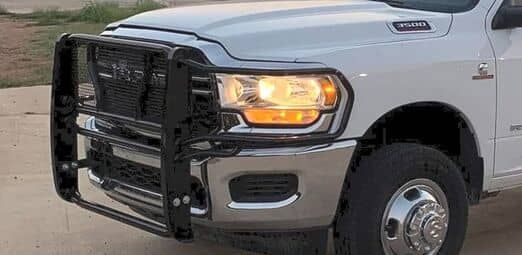 photo of white truck with black grill guard bumper