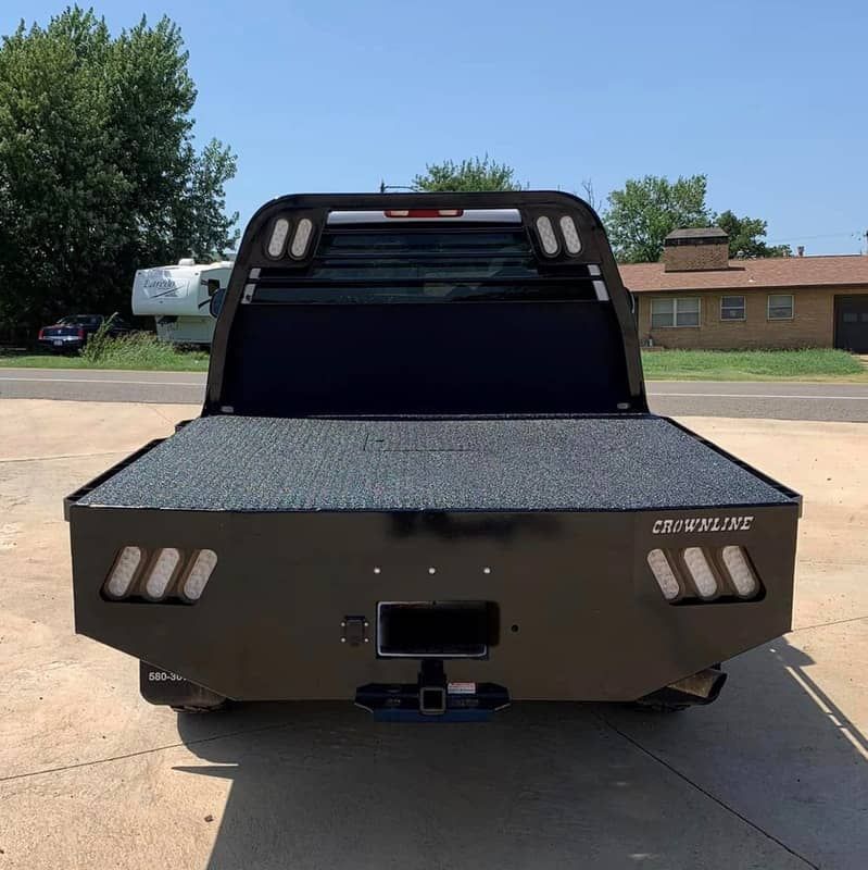 a truck with a flatbed that has the word crownline on it