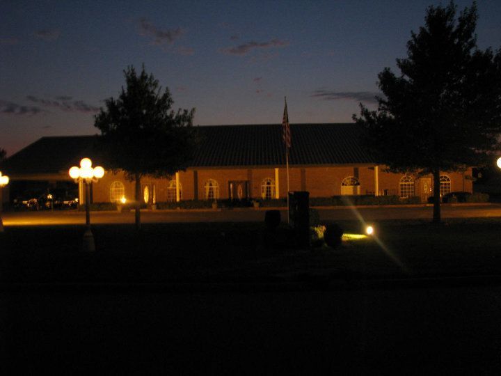 A man , woman and child are hugging each other and smiling.