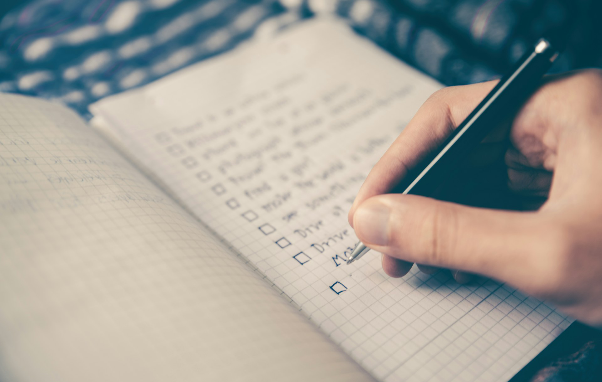 A man and a woman are sitting on a couch looking at a laptop computer.