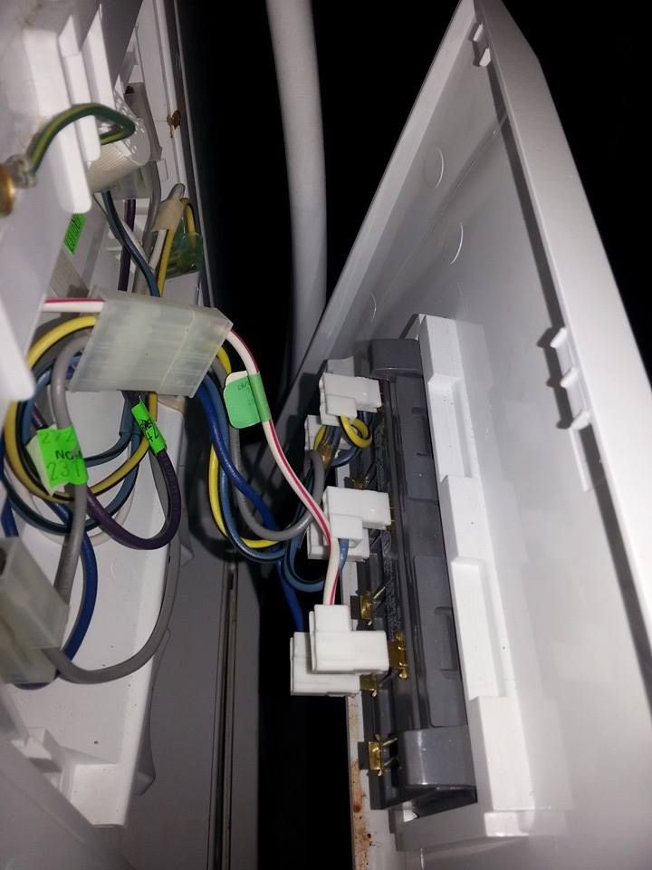 A white box with a bunch of wires coming out of it