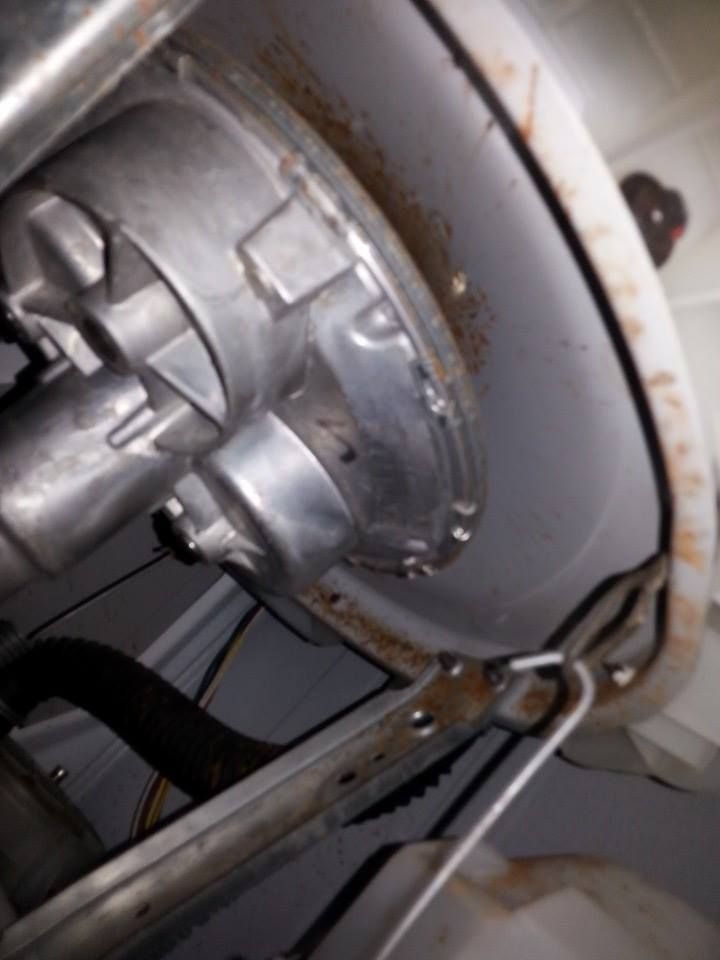 A close up of a metal object with a hose attached to it