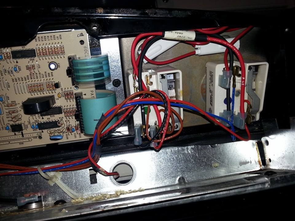 A close up of a circuit board with wires coming out of it