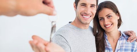Happy Couple Being Given a House Key — Home security in Annapolis, MD