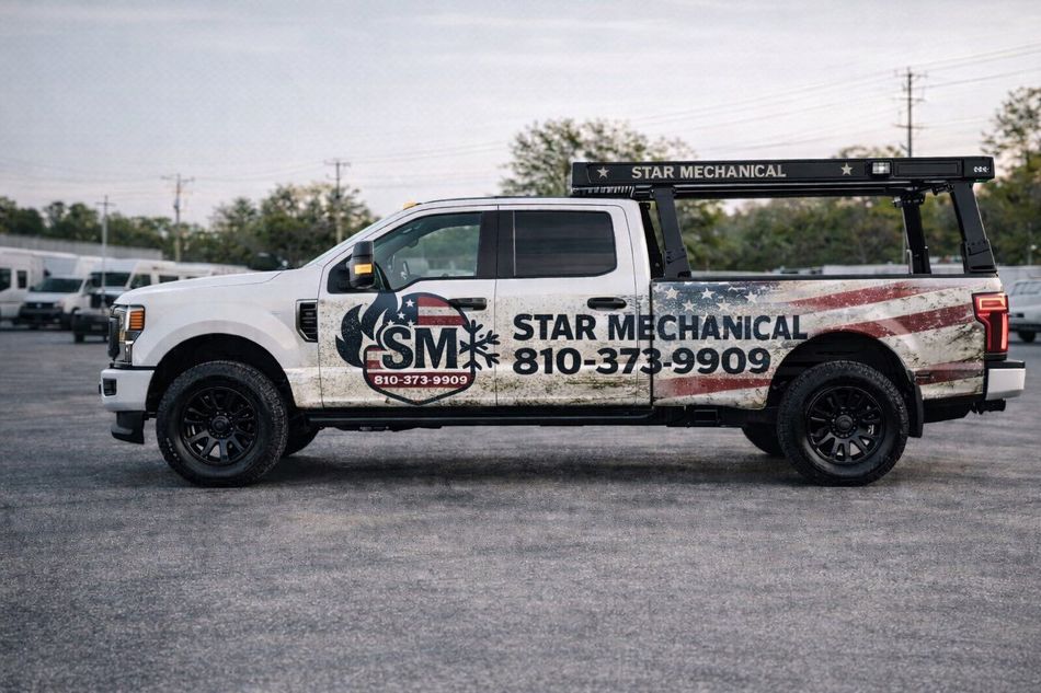 A white Star Mechanical service truck with an American flag decal parked in a gravel lot.