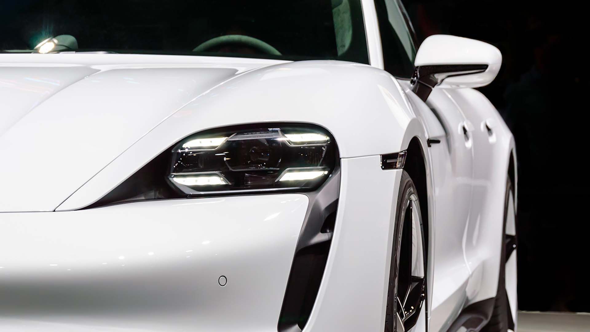 a close up of the headlight of a white car