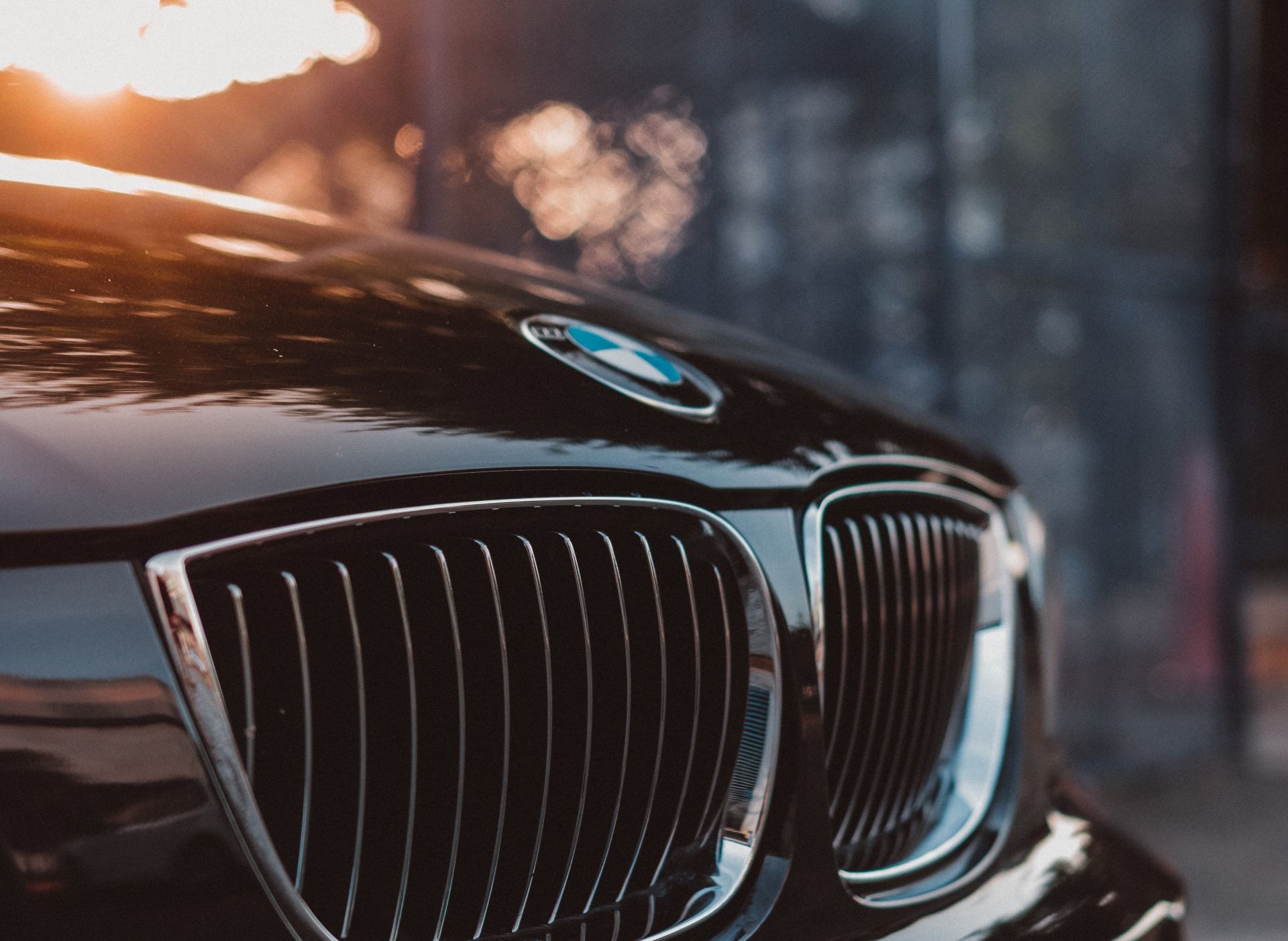a close up of the front of a black bmw car .