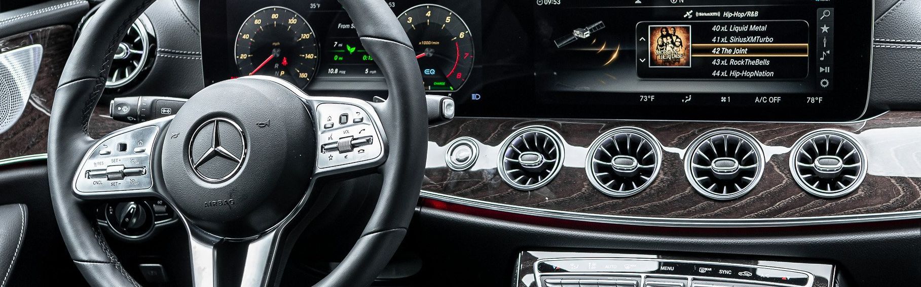 the interior of a mercedes benz car with a steering wheel and dashboard .