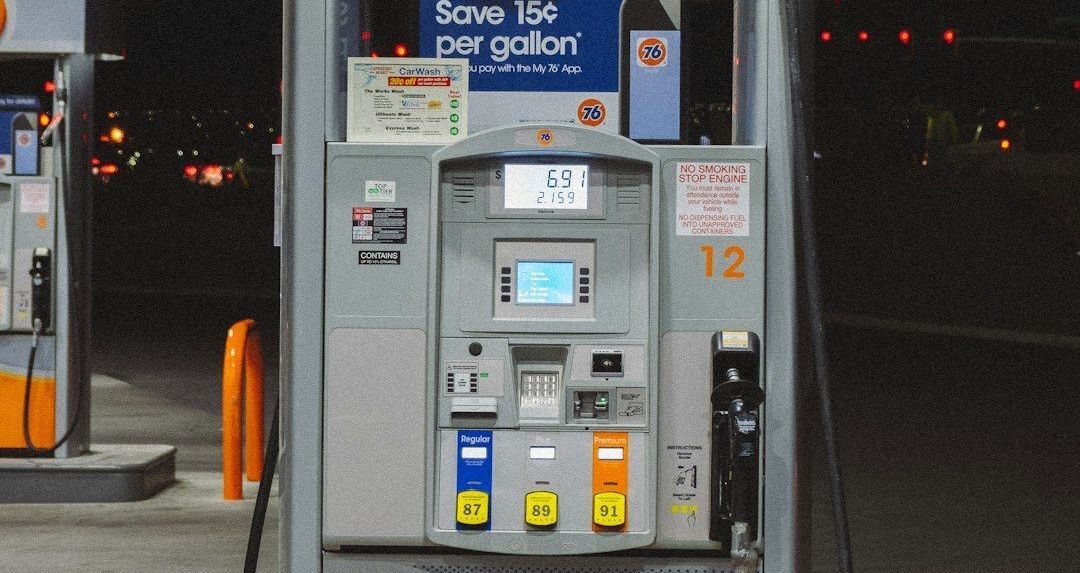 A 76 gas pump at a gas station at night