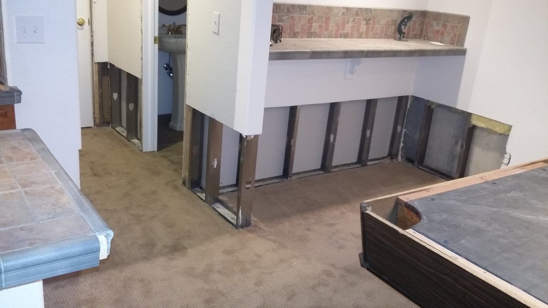 A room with a pool table and a sink in it