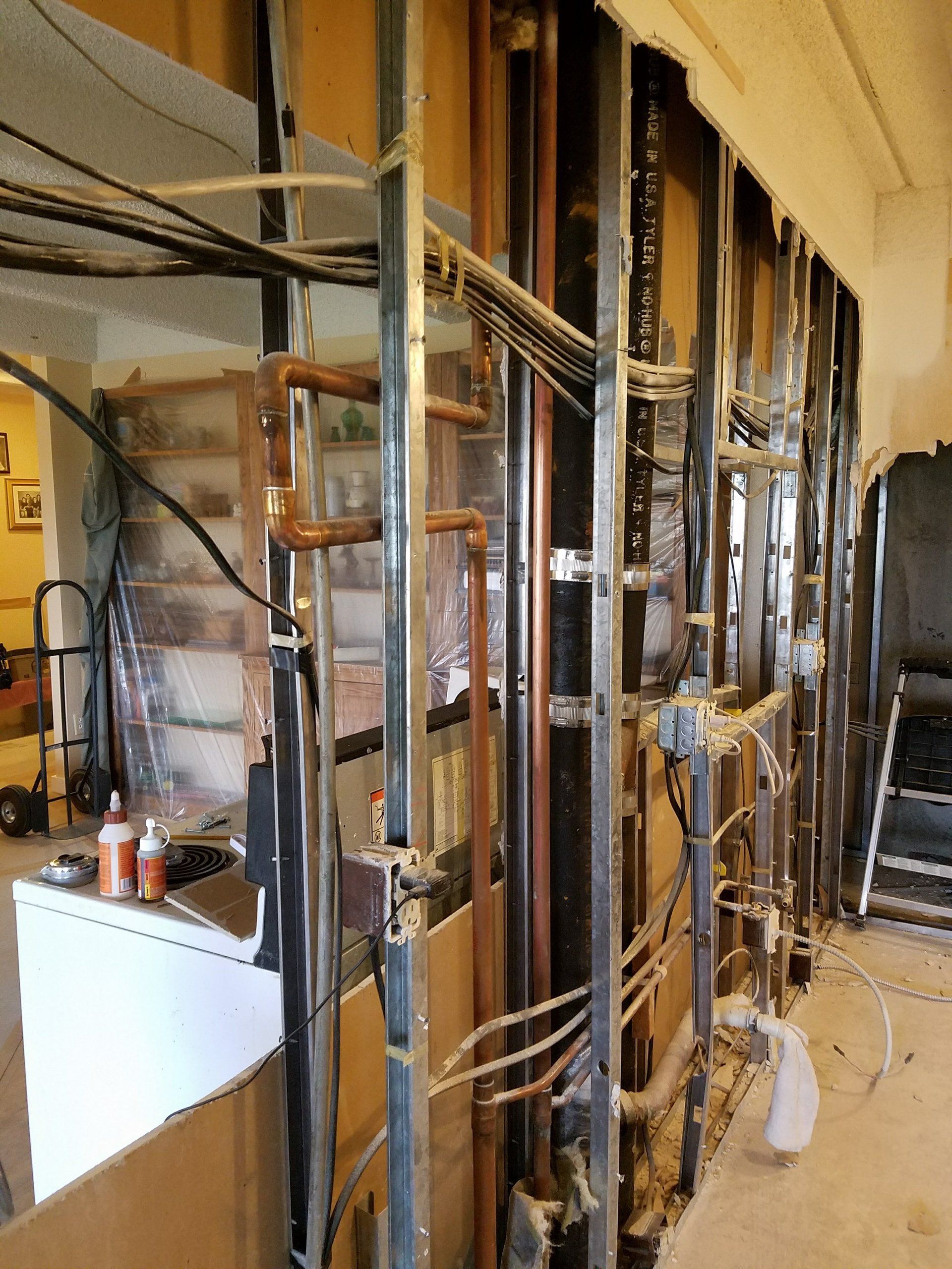 A room with a lot of pipes and wires in it