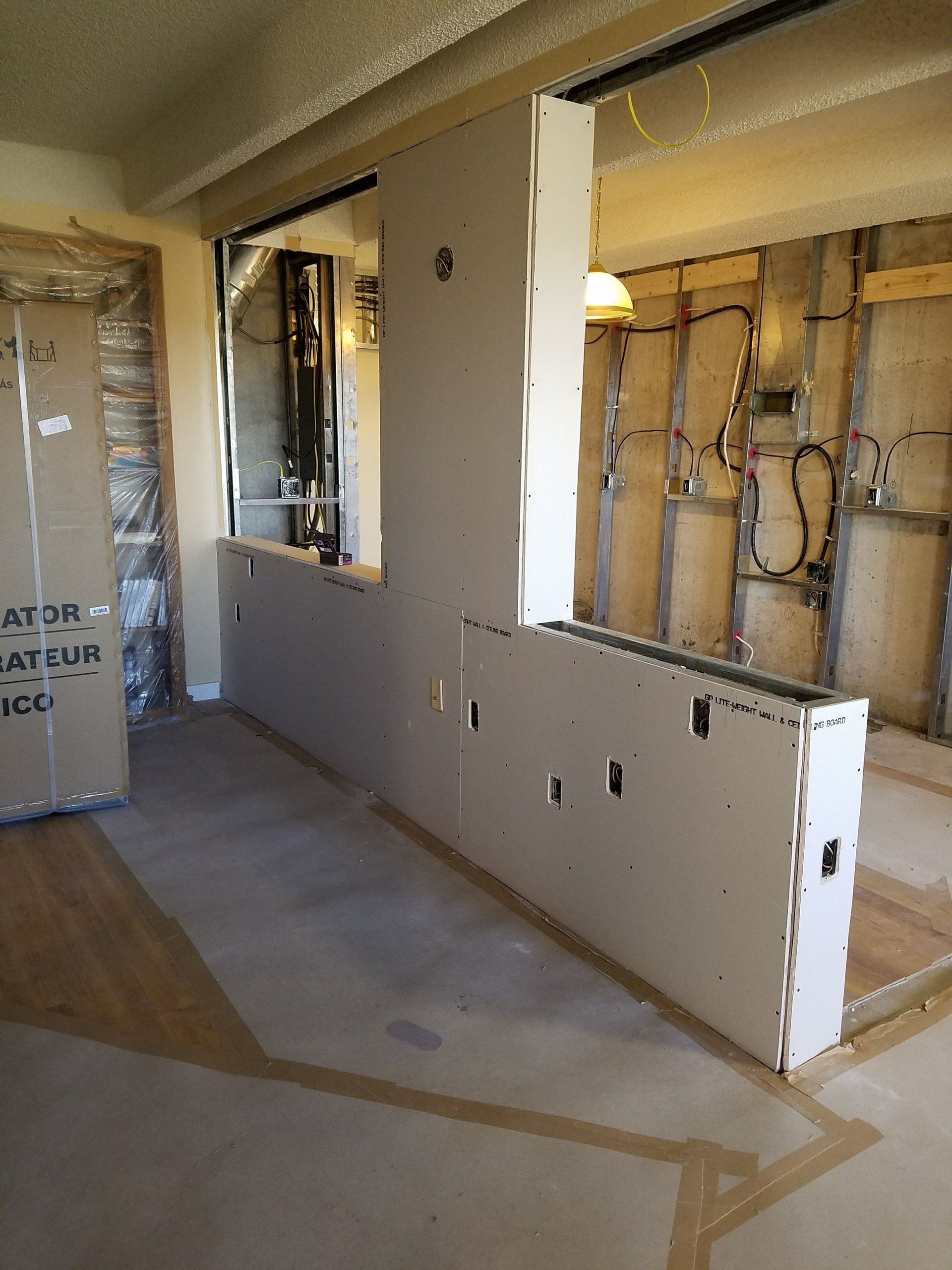 A room that is being remodeled with a box on the floor that says at35