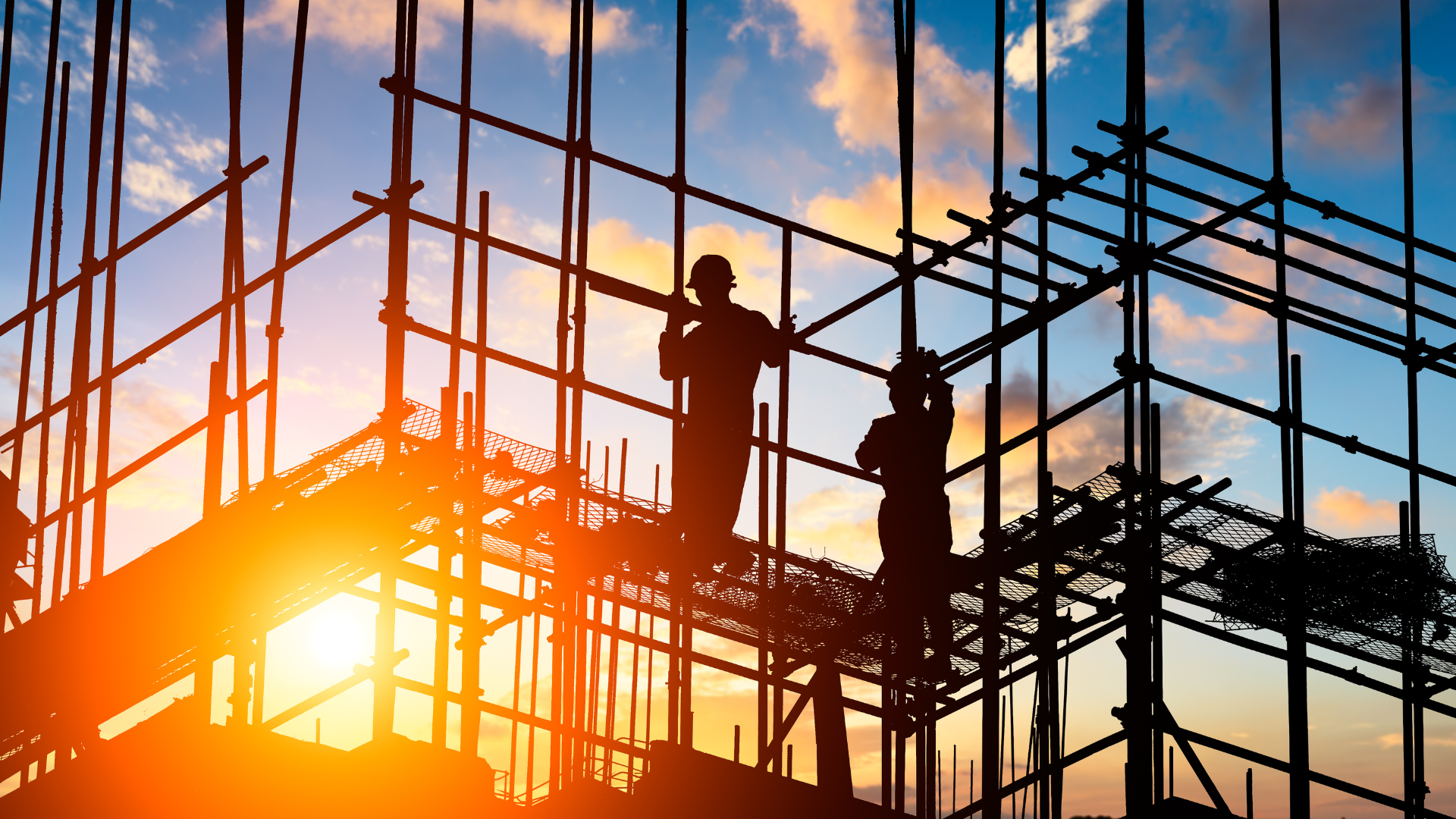 a construction site with the sun shining through the scaffolding